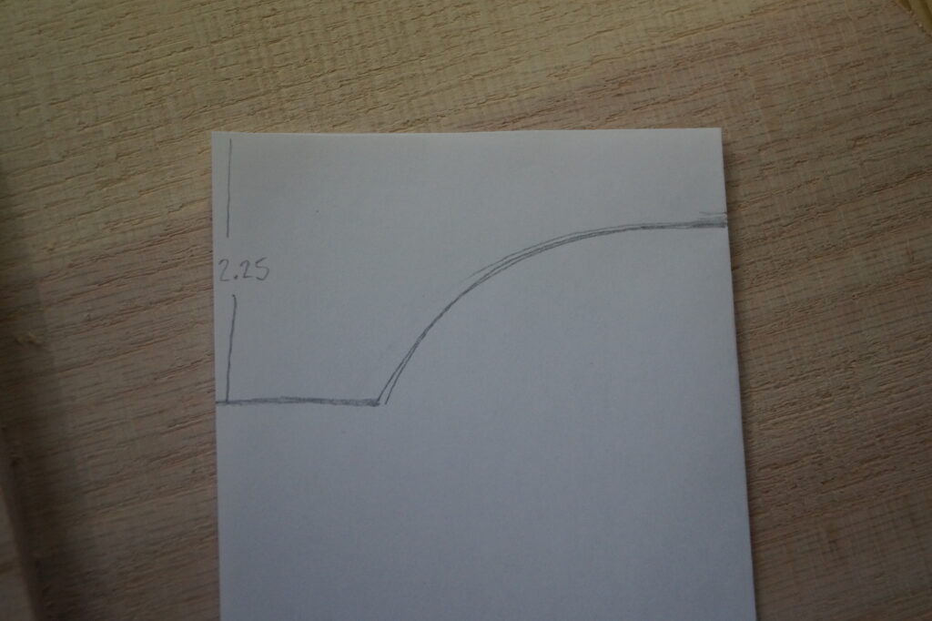 curved pattern drawn on folded sheet of paper