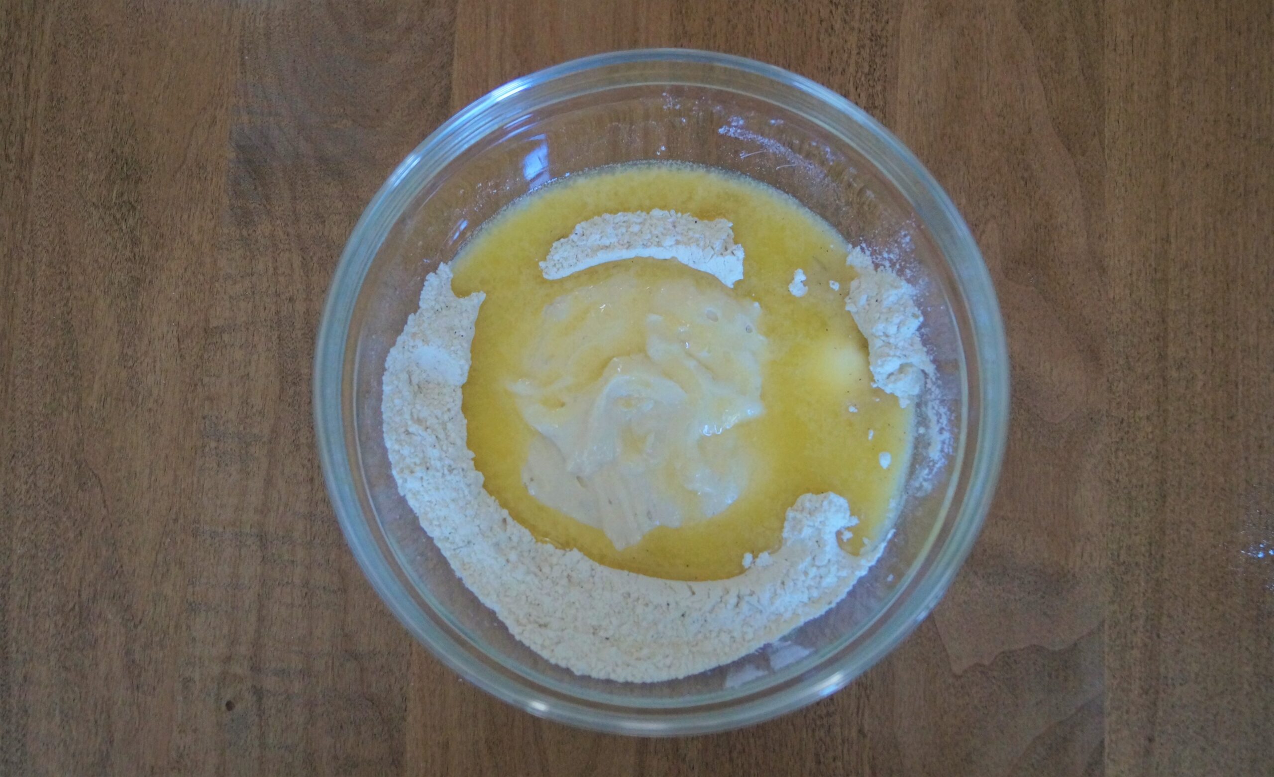 adding wet ingredients (butter and sourdough discard) to crackers dough