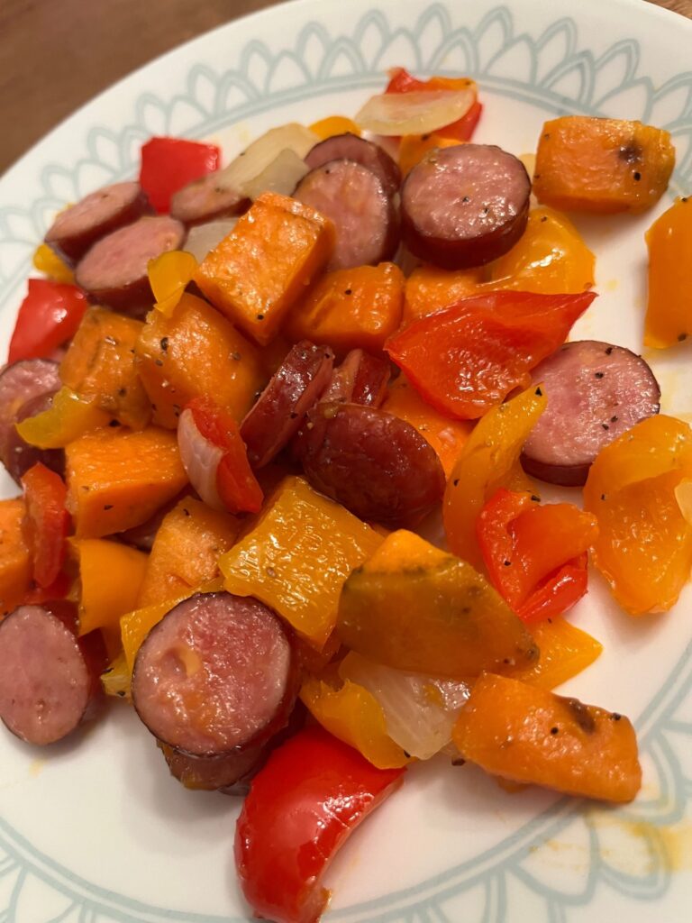 cooked Cheesy Sausage, peppers, and onions on a plate 