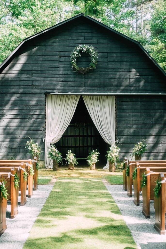 Outdoor barn wedding with church pews 