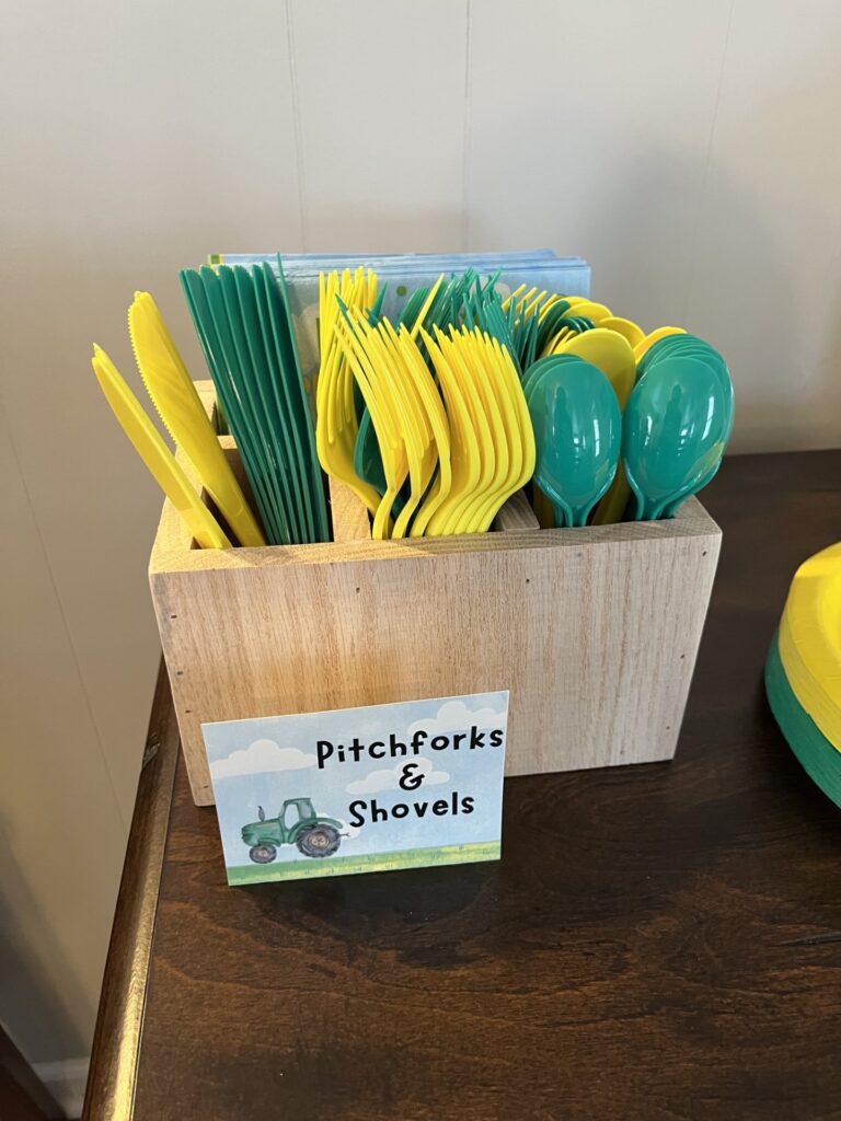 green and yellow plastic utensils representing pitchforks and shovels 